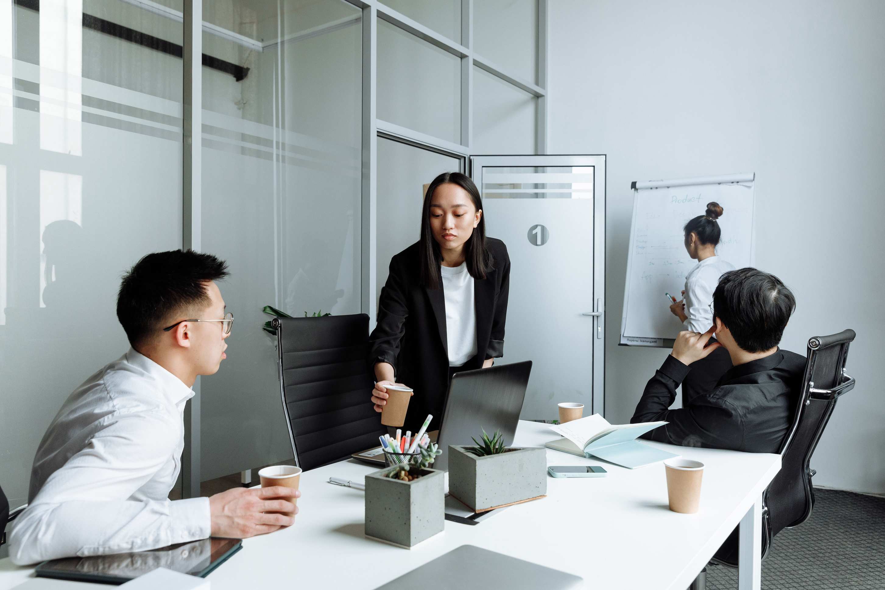 Small group reviewing documents at an office table during a meeting