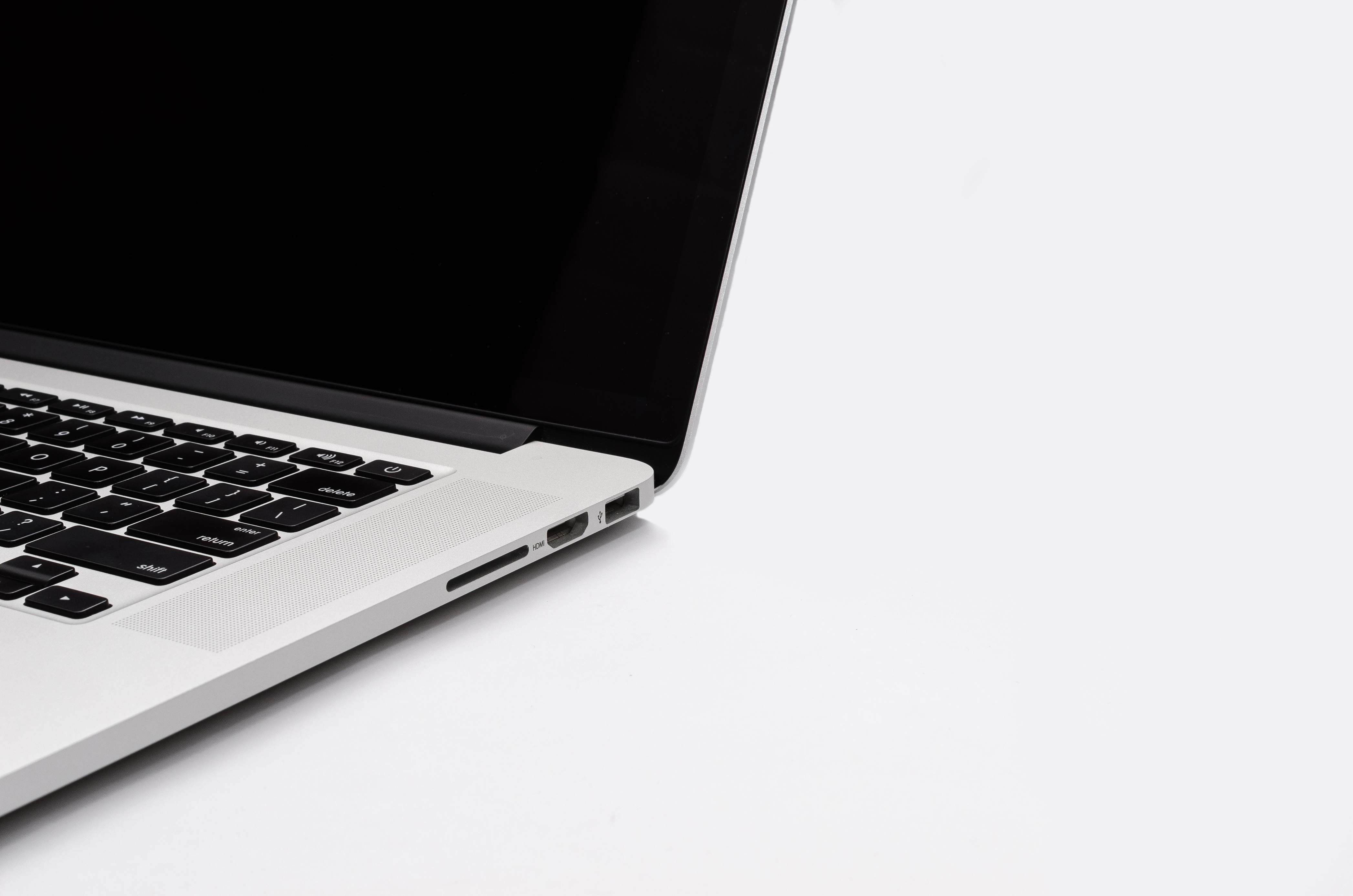 Close view of a laptop keyboard and screen on a desk